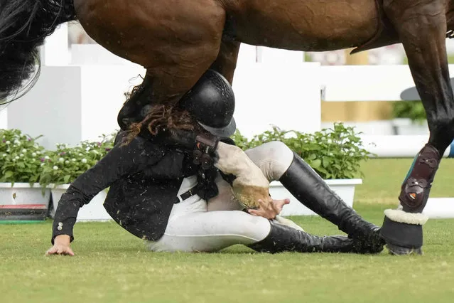 Leda Guimaraes of Brazil falls as she competes in the horse jumping portion of the women's modern pentathlon at the 2020 Summer Olympics, Friday, August 6, 2021, in Tokyo, Japan. (Photo by Andrew Medichini/AP Photo)