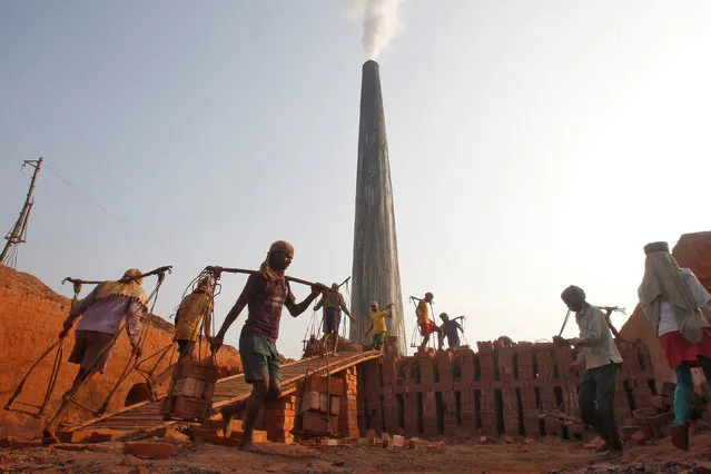 Labourers work at a brick kiln on the outskirts of Agartala, India, January 17, 2017. (Photo by Jayanta Dey/Reuters)
