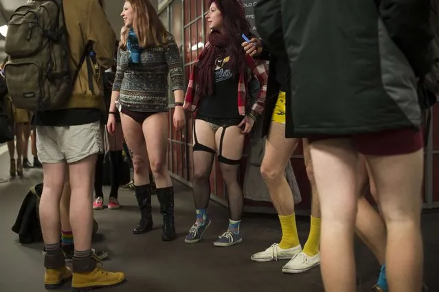 Participants of the “No Pants Subway Ride” stand on the platform at the Potsdamer Platz station waiting for the U2 Subway line in Berlin on January 12, 2014. (Photo by Odd Andersen/AFP Photo)