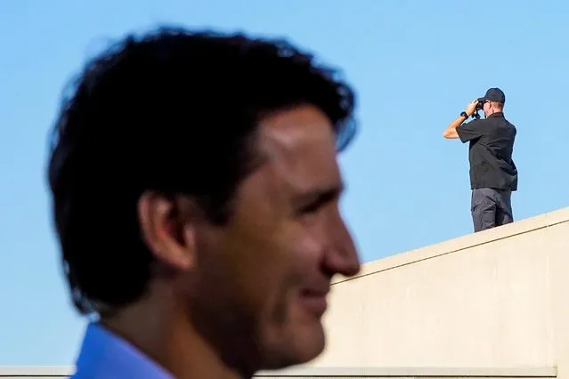 Security uses binoculars on a roof as Canada's Liberal Prime Minister Justin Trudeau holds an election campaign stop in Windsor, Ontario Canada on September 17, 2021. (Photo by Carlos Osorio/Reuters)