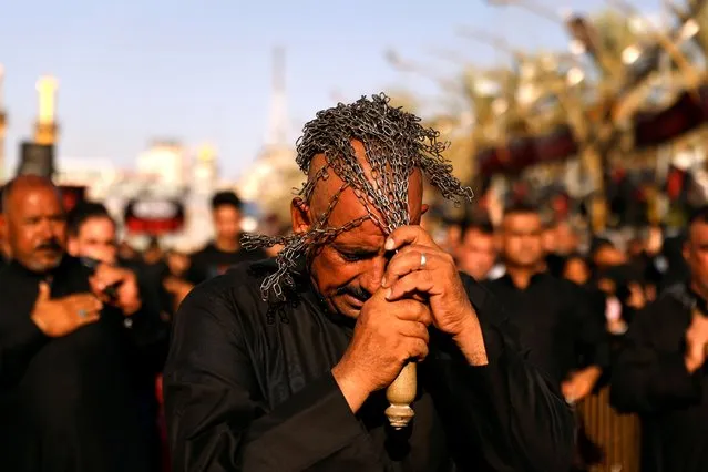 Shi'ite pilgrims flagellate themselves ahead of Ashura, the holiest day on the Shi'ite Muslim calendar in the holy city of Kerbala, Iraq, August 18, 2021. (Photo by Abdullah Dhiaa Al-Deen/Reuters)