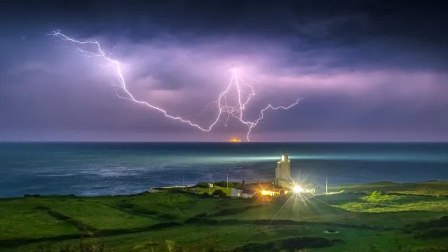 Storms over southern England in the small hours of yesterday morning,  July 24, 2021, outshone the lighthouse at St Catherine’s Point on the Isle of Wight, south coast of England. (Photo by Island Visions/BNPS)