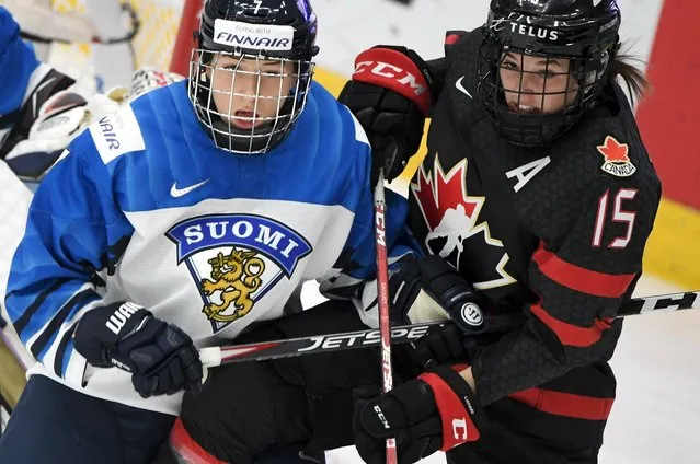 Nelli Laitinen of Finland, left, vies with Melodie Daoust of Canada during the IIHF Women's Ice Hockey World Championships semifinal match between Canada and Finland in Espoo, Finland, Saturday, April 13, 2019. (Photo by Jussi Nukari/Lehtikuva via AP Photo)