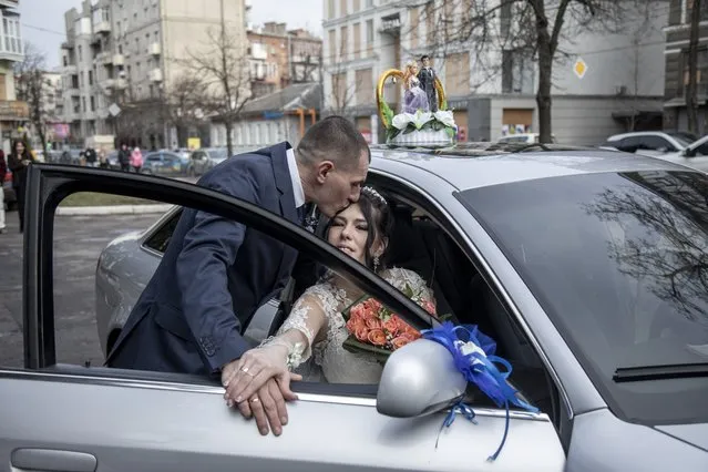 A couple is seen as they celebrate their wedding in downtown Kharkiv, Ukraine on February 14, 2024. Dozens of Ukrainian servicemen and civilians gathered during Valentine's Day to celebrate their wedding amid ongoing Russia-Ukraine war. (Photo by Narciso Contreras/Anadolu via Getty Images)