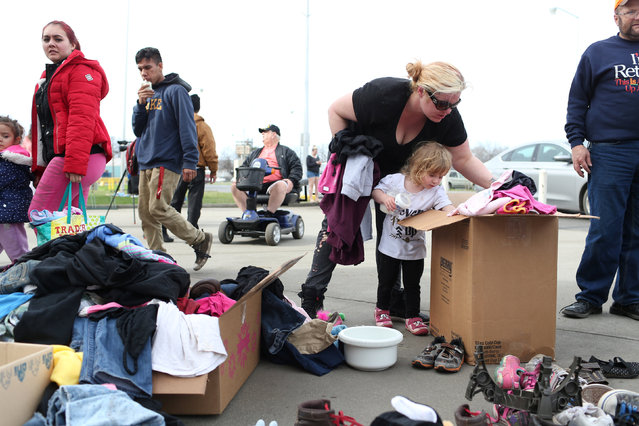 Desiree Garcia and her daughter Kay'lee, of Oroville, sift through donated clothing at a Red Cross relief center in Chico, California, after an evacuation was ordered for communities downstream from the Lake Oroville Dam in Oroville, California, U.S. February 13, 2017. (Photo by Beck Diefenbach/Reuters)
