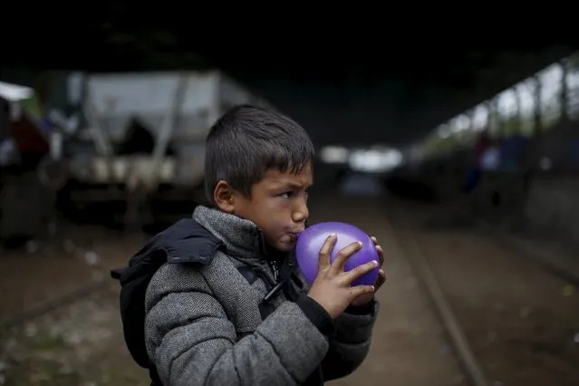 A child inflates a balloon at a makeshift camp for migrants and refugees at the Greek-Macedonian border near the village of Idomeni, Greece, April 3, 2016. (Photo by Marko Djurica/Reuters)