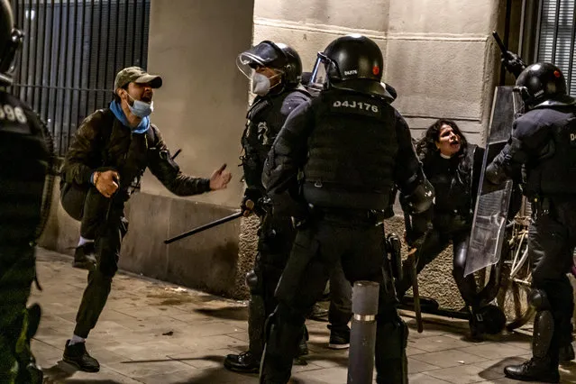 Agents of the mossos d'esquadra arresting protesters, during the demonstration in Barcelona, Spain on February 21, 2021. Sixth night of protests and riots in response to the arrest and imprisonment of rapper Pablo Hasel accused of exalting terrorism and insulting the crown in the content of the lyrics of his songs. (Photo by Paco Freire/SOPA Images/Rex Features/Shutterstock)