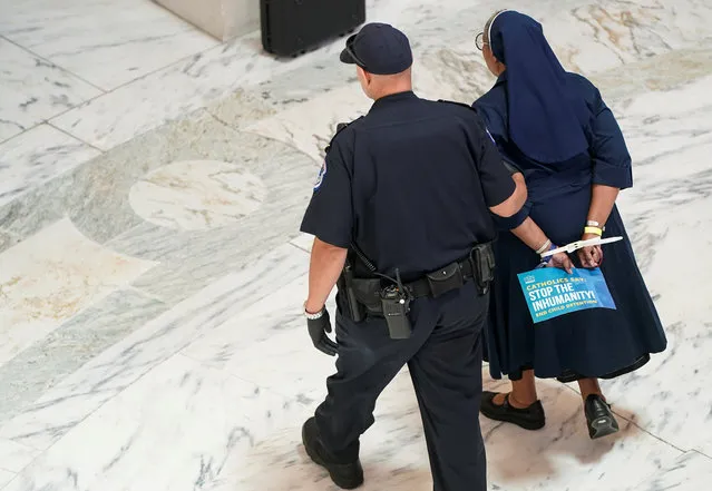 One of a members of the Franciscan Action Network and immigration rights activists is arrested during a demonstration calling for the end of immigrant detention on Capitol Hill in Washington, U.S., July 18, 2019. (Photo by Joshua Roberts/Reuters)