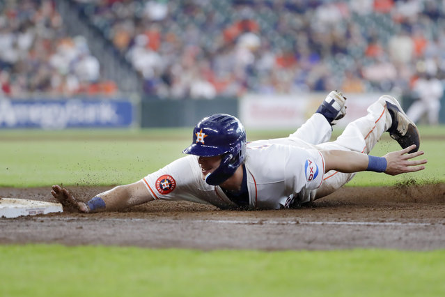 Houston Astros' Jake Meyers beats the tag on a return to first base against the Los Angeles Angels during the seventh inning of a baseball game Wednesday, May 22, 2024, in Houston. (Photo by Michael Wyke/AP Photo)
