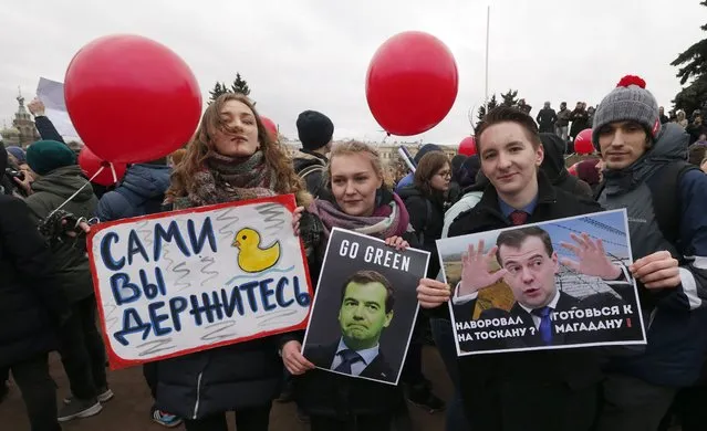 People hold posters of Russian Prime Minister Dmitry Medvedev as they take part in an opposition rally in St.Petersburg, Russia, 26 March 2017.Thousands of Russians throughout Russia took part in so-called anti-corruption rallies organized by opposition despite of authorities ban. Earlier in March 2017 Russian opposition leader Alexei Navalny's Anti-Corruption Fund released a report accusing Russian Prime Minister Dmitry Medvedev in owning huge properties. According to reports, dozens of demonstrators have been detained across the country as they called for the resignation of Russian Prime Minister Dmitry Medvedev over corruption allegations. (Photo by Anatoly Maltsev/EPA)
