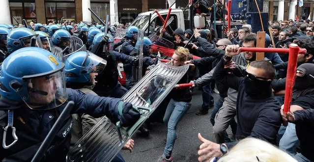 Riot police clash with demonstrators during a march in Turin, northern Italy, 01 May 2014 to mark International Labour Day. (Photo by Alessandro Di Marco/EPA)