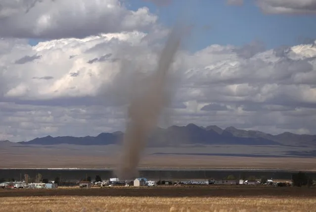 Dust blows through the desert in Rachel, Nevada on September 19, 2019. The influx of alien hunters prompted Lincoln County, which encompasses both Rachel and Hiko, to draft an emergency declaration that could be invoked to call in help from the state. The sheriff's office said visitors should expect “a large presence of law enforcement”. Authorities urged everyone to bring ample supplies of food, water and fuel. (Photo by Jim Urquhart/Reuters)