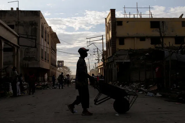 A man pushes a wheelbarrow in a street of Port-au-Prince, Haiti, February 14, 2017. (Photo by Andres Martinez Casares/Reuters)