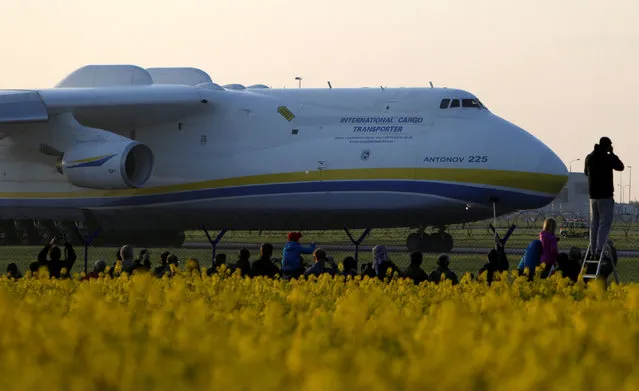 Plane spotters watch Antonov An-225 Mriya, a cargo plane which is the world's biggest aircraft, driving along the Vaclav Havel Airport for its first commercial flight from Prague to Perth, in Prague, Czech Republic, May 12, 2016. (Photo by David W. Cerny/Reuters)