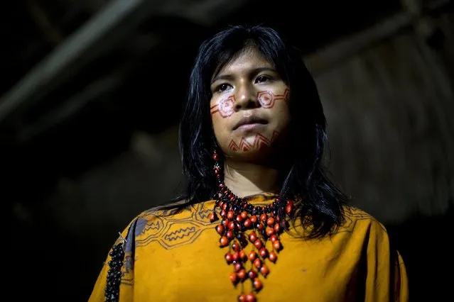 In this June 23, 2015 photo, Yeni Casiano Barboza, 15, from the Ashaninka Indian community, Natividad, poses for a photo while waiting to compete in the annual beauty contest, in the Otari Nativo village, Pichari, Peru. For Ashaninka men, a woman's beauty is determined in part by her hair, her sense of humor, and whether she can cook a tasty cassava dish, according to some community members. (Photo by Rodrigo Abd/AP Photo)