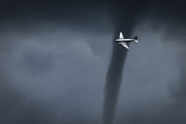 A mini-tornado forms behind a DC3 during the air show on May 18, 2024 in La Ferte-Alais, south of Paris, France. France’s premier air show is held each year at Cerny aerodrome, close to the picturesque town of La Ferte-Alais, just a short distance from Paris. The event itself takes place during the weekend of Pentecost, fifty days after Easter, and thus the date for any given year varies between mid-May and mid-June. (Photo by Thomas Arnoux/ABACA Press)