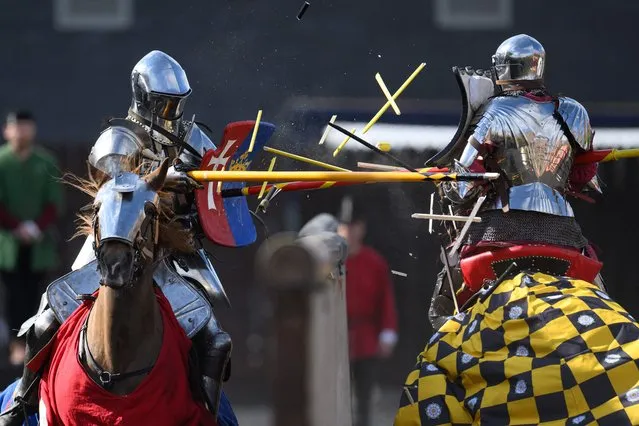 Riders dressed as knights take part in the International Jousting Tournament, held at the Royal Armouries Museum in Leeds, northern England on April 18, 2022. The four-day tournament, running from April 15 to 18, 2022, has seen knights from Norway, Portugal and the UK battle to be awarded the museum's Sword of Honour and Queen's Jubilee Trophy. The competition is the first time the Royal Armouries Museum has staged a tournament since the Covid-19 pandemic. Points are awarded for: horsemanship, lance skills as well as the accuracy and striking power in the joust. (Photo by Oli Scarff/AFP Photo)