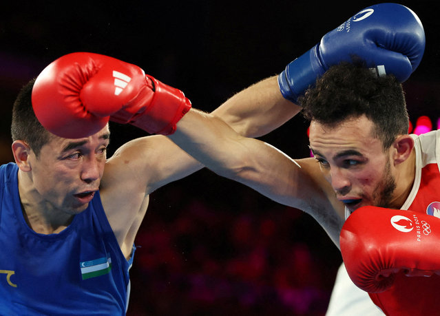 France's Billal Bennama and Uzbekistan's Hasanboy Dusmatov (Blue) compete in the men's 51kg final boxing match during the Paris 2024 Olympic Games at the Roland-Garros Stadium, in Paris on August 8, 2024. (Photo by Maye-E Wong/Reuters)