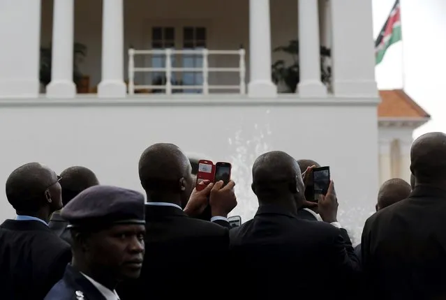 Kenyan staff members look on as U.S. President Barack Obama and Kenya's President Uhuru Kenyatta (neither pictured) hold a joint news conference after their meeting at the State House in Nairobi July 25, 2015. (Photo by Jonathan Ernst/Reuters)