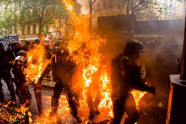 Incredible photo capture police offivers ON FIRE as they clash with protesters during a demonstration on May Day (Labour Day), to mark the international day of the workers in Paris, France on May 1, 2023. (Photo by Florian Poitout/AbacaPress/Splash News and Pictures)