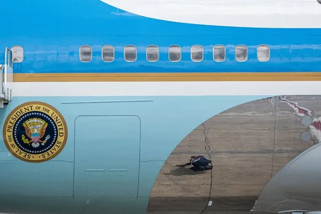 A U.S. Secret Service agent walks under Air Force One at the Portland Air National Guard Base before U.S. President Joe Biden deplaned to deliver remarks on infrastructure on April 21, 2022 in Portland, Oregon. The speech marks the beginning of the president's multi-day trip to the Northwest, with stops in Portland and Seattle Washington. (Photo by Nathan Howard/Getty Images)