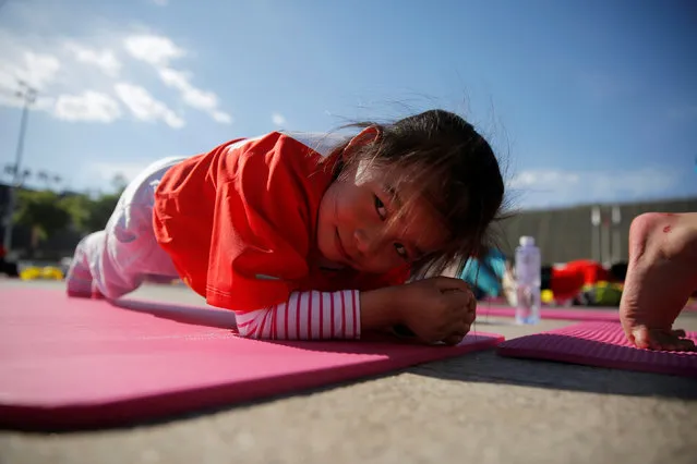 A participant does planking at the Plank Sport Carnival in Beijing, China, May 15, 2016. (Photo by Kim Kyung-Hoon/Reuters)