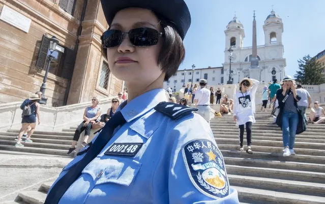 A Chinese police officer patrols in front of the Spanish Steps, in Rome, Monday, June 5, 2017.  The Italian-Chinese joint patrolling is aimed at making Chinese tourists feel safe. The Chinese, who speak Italian, received training from Italian officials in Beijing. Three million Chinese tourists visit Italy annually. (Photo by Claudio Peri/ANSA via AP Photo)