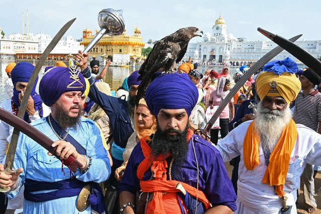 Sikh devotees take part in a religious procession from the Gurudwara Ramsar to Akal Takht Sahib at the Golden Temple in Amritsar on September 4, 2024, on the occasion of the anniversary of installation of the Sikh holy book Guru Granth Sahib. (Photo by Narinder Nanu/AFP Photo)