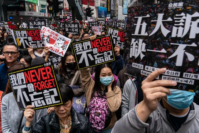 Pro-democracy supporters hold placards and shout slogan as they take part in a march during a rally on New Years Day on January 1, 2020 in Hong Kong, China. Anti-government protesters in Hong Kong continue their demands for an independent inquiry into police brutality, the retraction of the word “riot” to describe the rallies, and genuine universal suffrage. (Photo by Anthony Kwan/Getty Images)