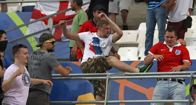 Russian supporters attack an England fan at the end of the Euro 2016 Group B soccer match between England and Russia, at the Velodrome stadium in Marseille, France, Saturday, June 11, 2016. (Photo by Thanassis Stavrakis/AP Photo)