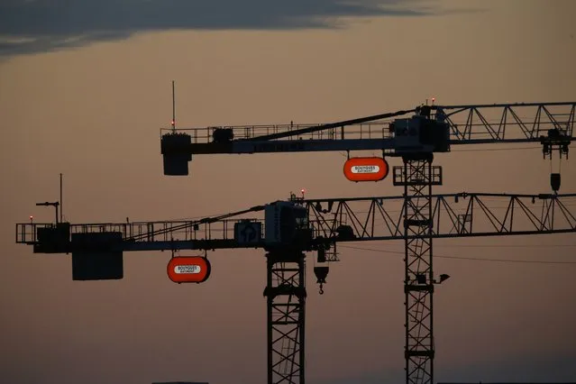 Two cranes with the French construction group Bouygues company logo are seen in the morning sky in Orly, France, near Paris, August 1, 2015. (Photo by Stephane Mahe/Reuters)