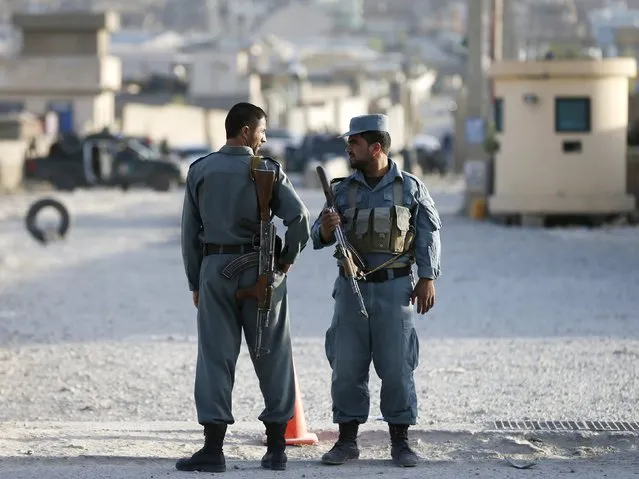 Afghan policemen keep watch at the site of an attack after an overnight battle outside a base in Kabul, Afghanistan August 8, 2015. (Photo by Mohammad Ismail/Reuters)