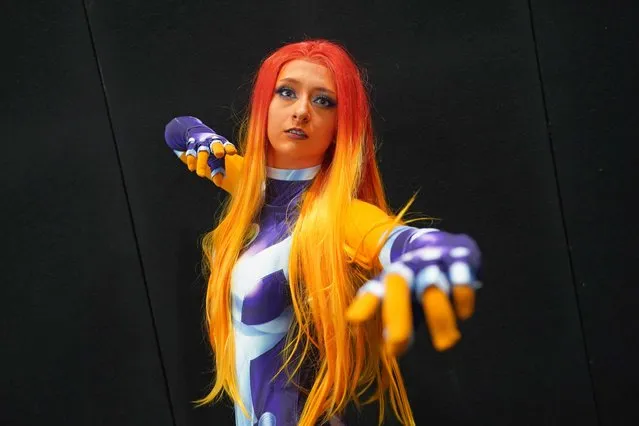 A cosplayer dressed as Starfire during the first day of MCM Comic Con at the ExCel London in east London, United Kingdom on Friday, October 22, 2021. (Photo by Ian West/PA Images via Getty Images)