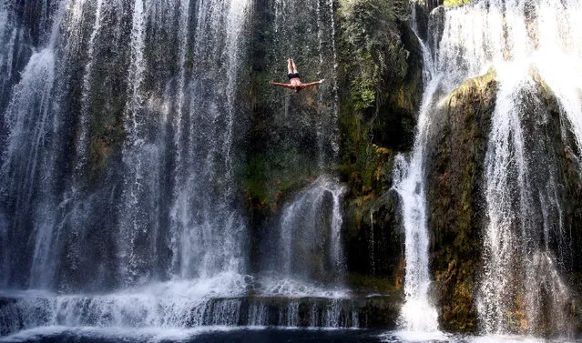 A competitor takes part in the annual international waterfall jumping competition held in the old town of Jajce, Bosnia and Herzegovina, August 5, 2017. (Photo by Dado Ruvic/Reuters)
