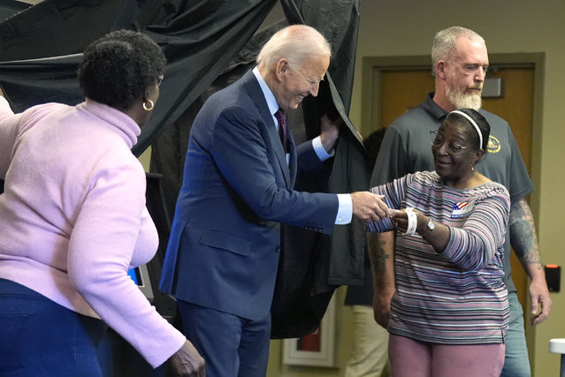 President Joe Biden is handed an “I Voted Early” sticker upon exiting the voting booth after casting his early-voting ballot for the 2024 general elections, Monday, October 28, 2024, in New Castle, Del. (Photo by Manuel Balce Ceneta/AP Photo)