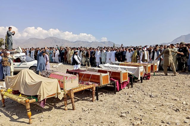 Sunni Muslim men gather to offer prayers during the funeral ceremony for victims who were killed in a tribal clash, at Kurram district in Khyber Pakhtunkhwa province on October 13, 2024. At least 16 people, including three women and two children, were killed in a fresh sectarian clash in Pakistan's northwest, officials said. Sunni and Shiite Muslim tribes have been engaged in intermittent fighting for several months in the Kurram district of Pakistan's Khyber Pakhtunkhwa province. (Photo by Dilawer Khan/AFP Photo)