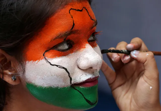 A girl gets her face painted in the colours of India's national flag, as she takes part in Independence Day celebrations inside a college in Chennai, August 15, 2017. (Photo by P. Ravikumar/Reuters)