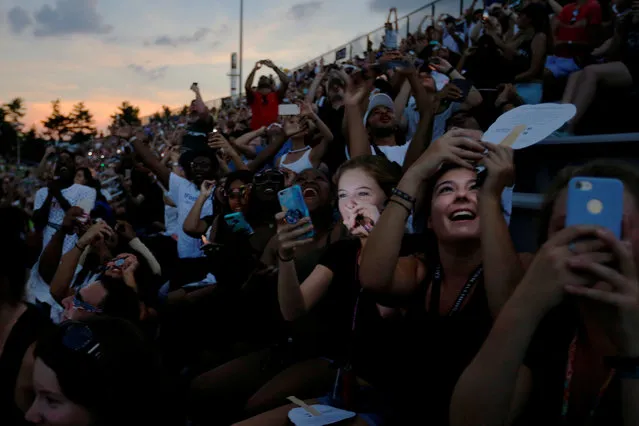 Guests react to the total eclipse in the football stadium at Southern Illinois University in Carbondale, Illinois on August 21, 2017. (Photo by Brian Snyder/Reuters)