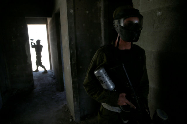 Israeli soldiers from the Nahal Infantry Brigade use paintball guns during an urban warfare training in the West Bank Jewish settlement of Alei Zahav, near Ariel July 13, 2016. (Photo by Baz Ratner/Reuters)