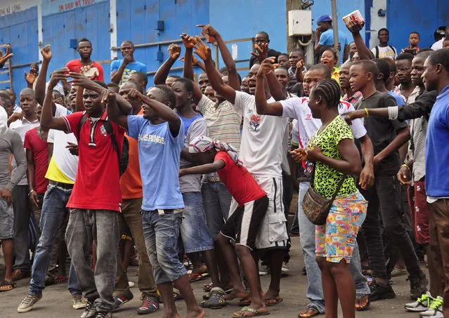 Residents from an area close to the West Point Ebola center, protest as they are not allowed to enter the area leading to their homes, after Liberia security forces blocked roads, as the government clamps down on the movement of people to prevent the spread of the Ebola virus in the city of Monrovia, Liberia, Wednesday, August 20, 2014. (Photo by Abbas Dulleh/AP Photo)