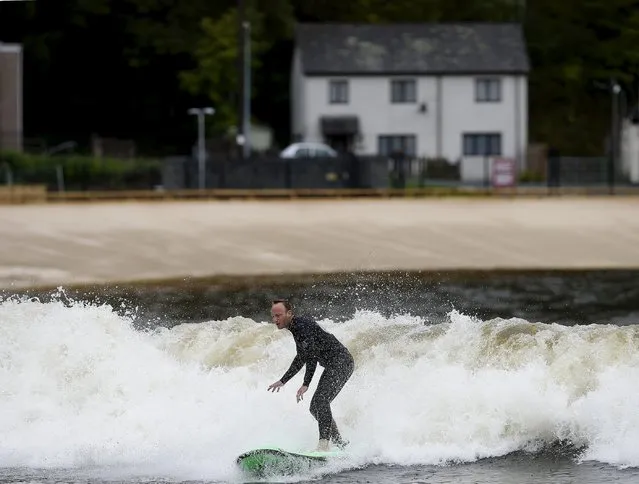 Surfers surf at Surf Snowdonia in Conwy, North Wales, September 3, 2015. (Photo by Andrew Yates/Reuters)