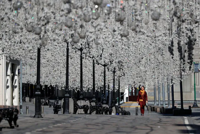 A woman walks along a decorated street in central Moscow, Russia on May 1, 2020. Russia marks the Spring and Labour Day without traditional demonstrations and celebrations due to the coronavirus disease (COVID-19) outbreak. (Photo by Shamil Zhumatov/Reuters)