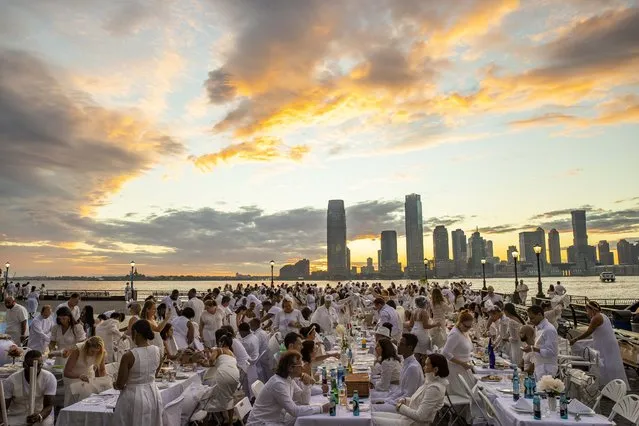 People attend the 10th edition of “Diner en Blanc” at Brookfield Place in Lower Manhattan, New York City, United States on September 19, 2022. “Diner en Blanc” returned to New York City on Monday after a two-year pause during the pandemic. (Photo by Aytac Unal/Anadolu Agency via Getty Images)
