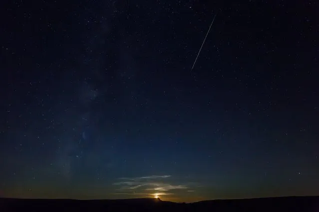 This picture taken on August 12, 2016 shows a Perseid meteor along the Milky Way illuminating the dark sky near Pesquera de Ebro in the province of Burgos, northern Spain, during the “Perseids” meteor shower. Northern hemisphere sky-gazers are in for a special treat on August 11, night with a rare shooting star “outburst”, which astronomers hope will not be marred by clouds and a bright Moon. (Photo by Cesar Manso/AFP Photo)