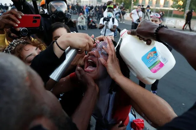 A demonstrator is doused with milk after being hit by an eye irritant during a protest against the death in Minneapolis police custody of George Floyd, in Minneapolis, Minnesota, U.S., May 30, 2020. (Photo by Lucas Jackson/Reuters)