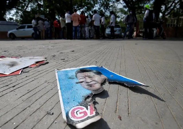 A damaged poster of Chinese President Xi Jinping lies on the ground during a protest against China organised by the members of National Students' Union of India (NSUI), in Ahmedabad, India, June 18, 2020. (Photo by Amit Dave/Reuters)