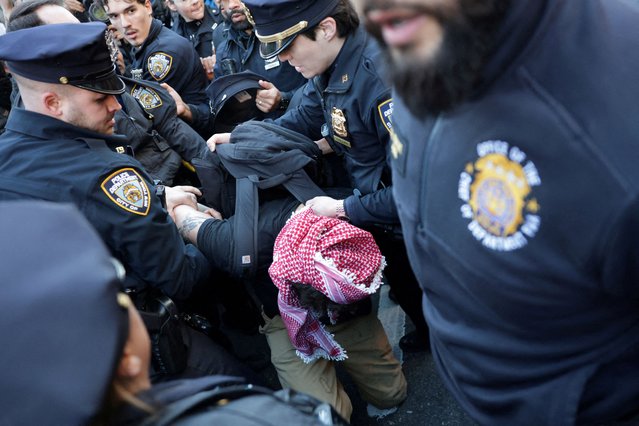 A demonstrator is detained by police officers during a protest following the arrest by US immigration agents of Palestinian student protester Mahmoud Khalil at Columbia University, in New York City on March 10, 2025. (Photo by Jeenah Moon/Reuters)