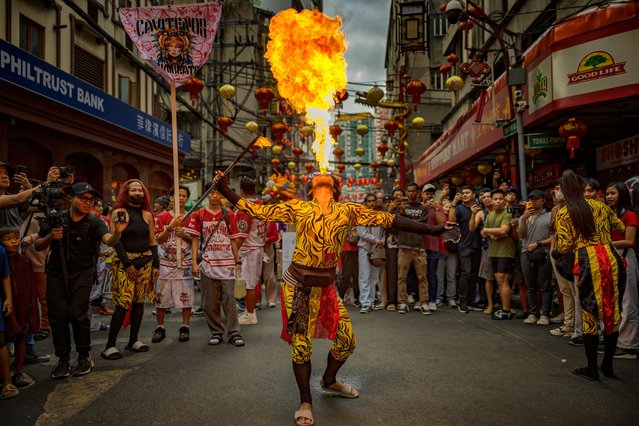 A performer breathes fire during Lunar New Year celebrations at Binondo district, considered the world's oldest Chinatown, on January 29, 2025 in Manila, Philippines. Chinese New Year, also known as Lunar New Year, will begin on January 29, 2025, marking the Year of the Snake. The celebrations, which last for approximately 15 days, are filled with traditional activities such as family gatherings, lion dances, and the exchange of red envelopes, making it a vibrant cultural event observed by Chinese communities worldwide. (Photo by Ezra Acayan/Getty Images)