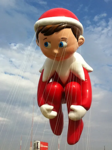 In this photo provided by Macy's, the “Elf on the Shelf” balloon floats over the Meadowland's race track during a test flight Saturday, November 10, 2012, in East Rutherford, N.J. (Photo by AP Photo/Macy's, Inc.)