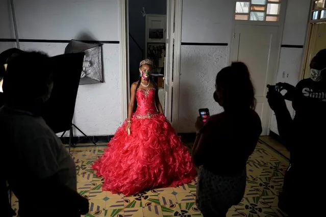 Naomi Ramos poses as she tries dresses for her quinceanera (coming of age of 15-year-olds) celebration amid coronavirus disease (COVID-19) spread concerns, in Havana, Cuba, July 13, 2020. (Photo by Alexandre Meneghini/Reuters)
